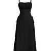Black cami dress with spaghetti straps, ruched bust, and a side bow detail, perfect for a stylish evening look.