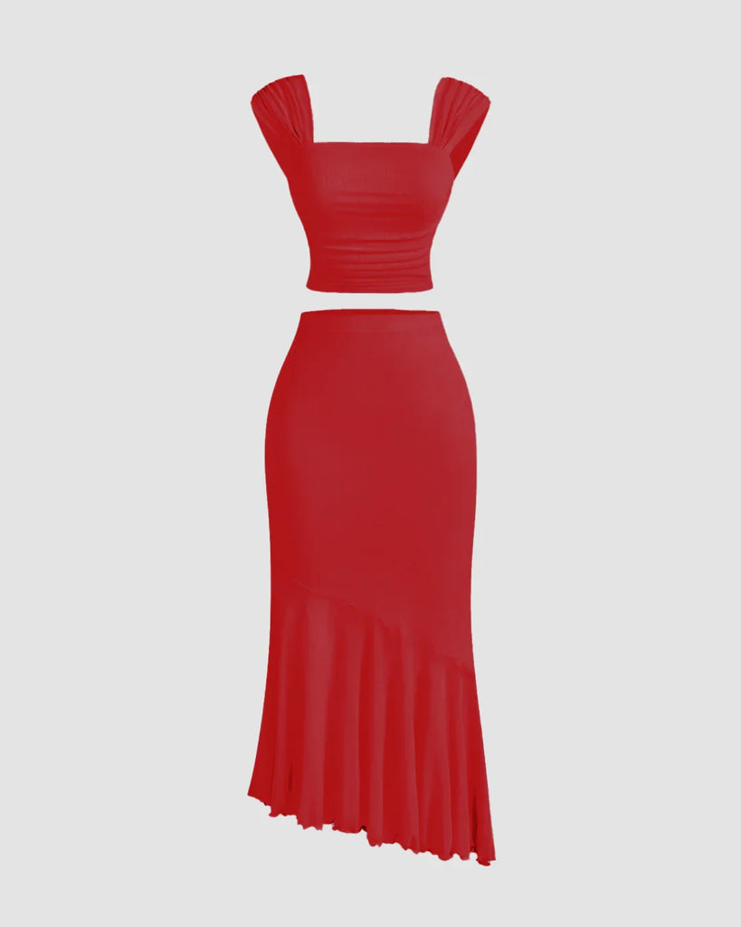 Dark red dress featuring a ruched crop top and a ruffled asymmetric hem skirt.
