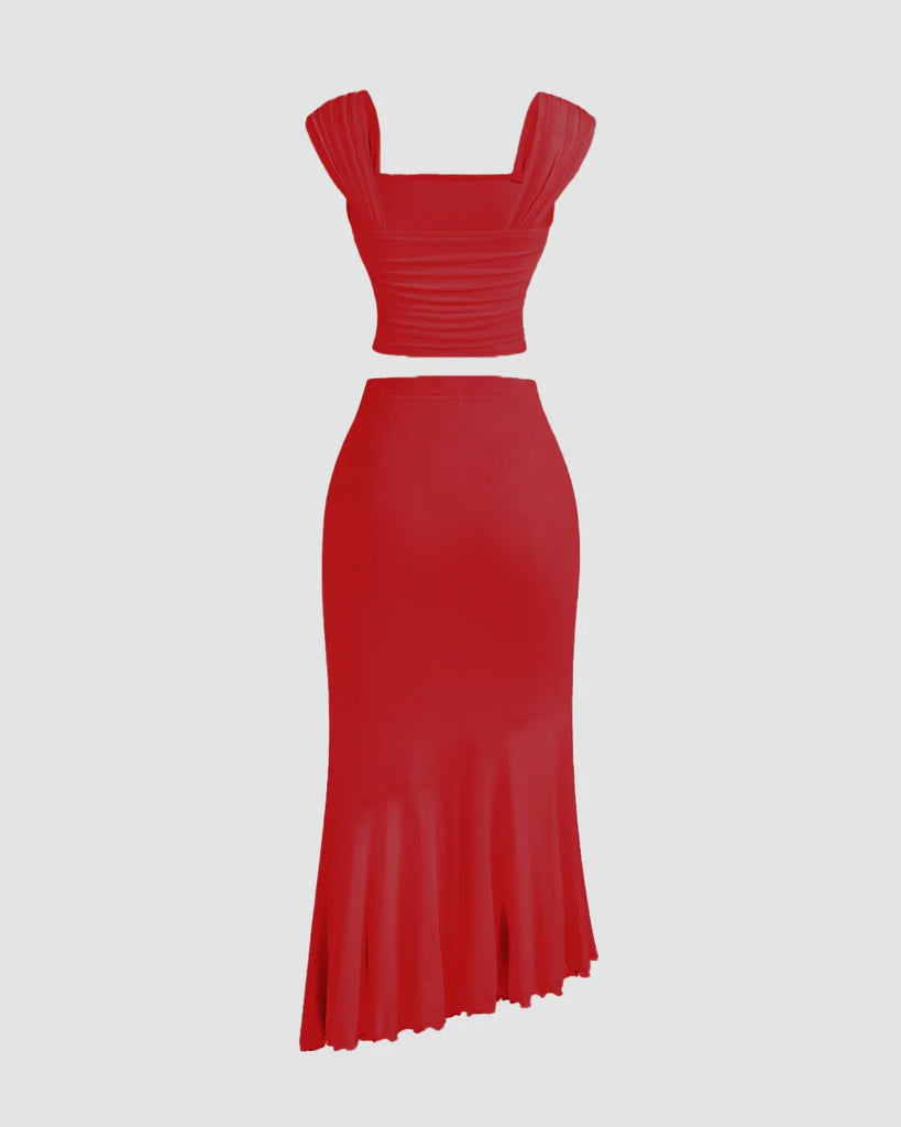 Back view of a Dark red dress featuring a ruched crop top and a ruffled asymmetric hem skirt.