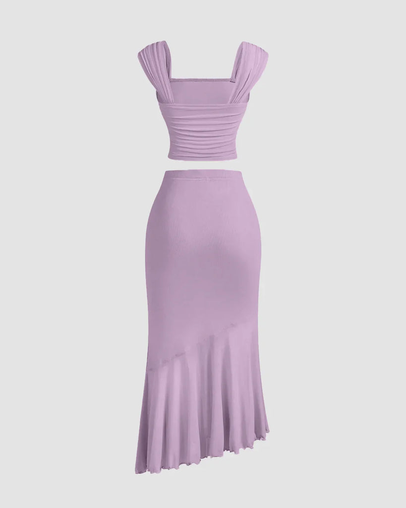Back view Soft, lightweight lilac dress featuring a ruched crop top and an asymmetric hem skirt set.
