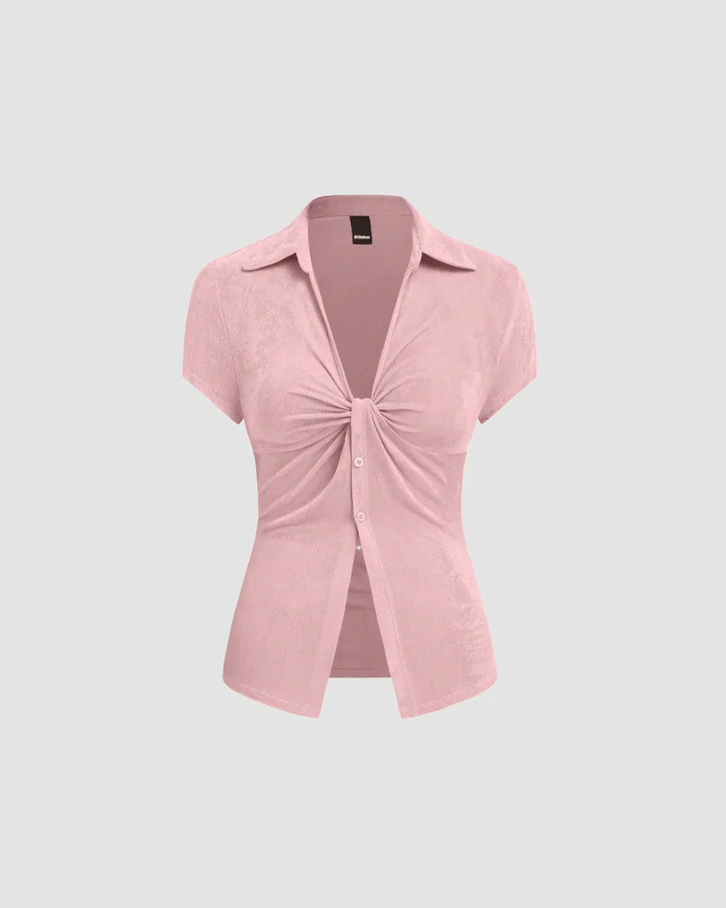short sleeve dusty pink top with a ruched front and pointed collar, showcasing a flattering silhouette