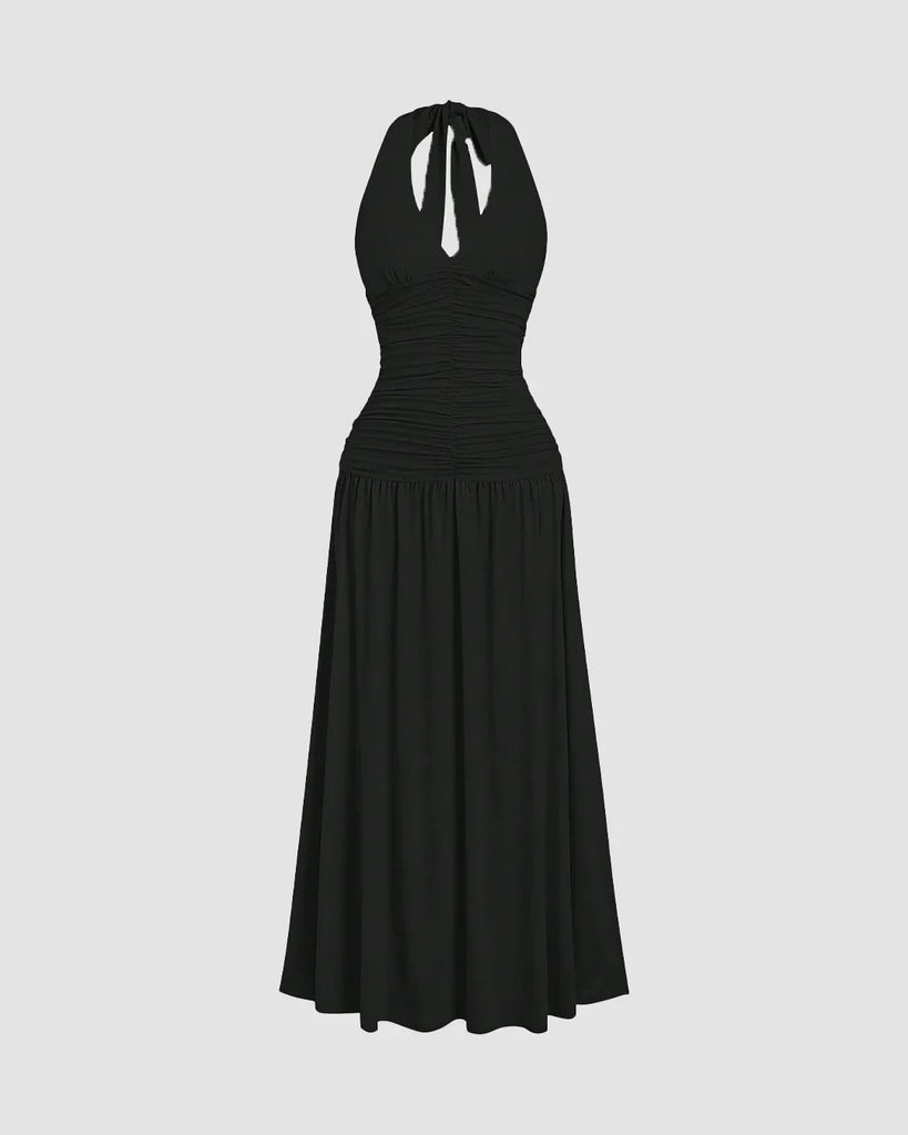 Ruched halter neck black midi dress featuring a gathered bust and flowy silhouette with a standout backless detail.