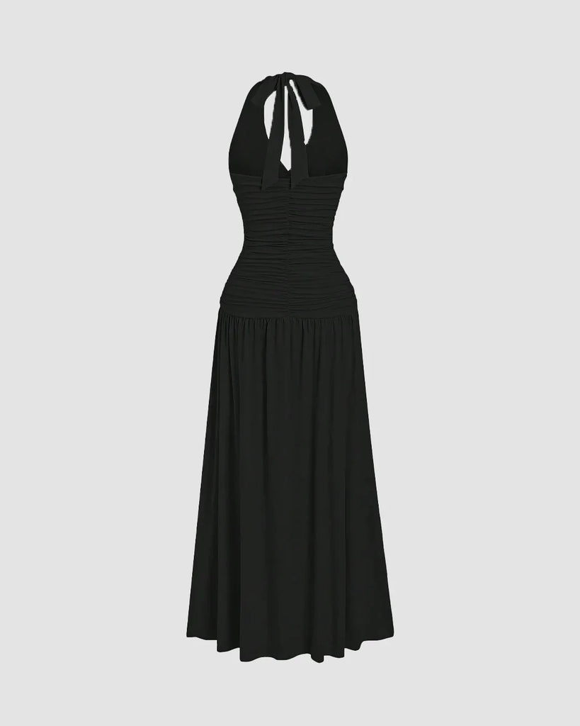 Ruched halter neck black midi dress featuring a gathered bust and flowy silhouette with a standout backless detail.