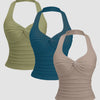 Three ruched halter neck tank tops in sage, beige, and teal blue displayed together.
