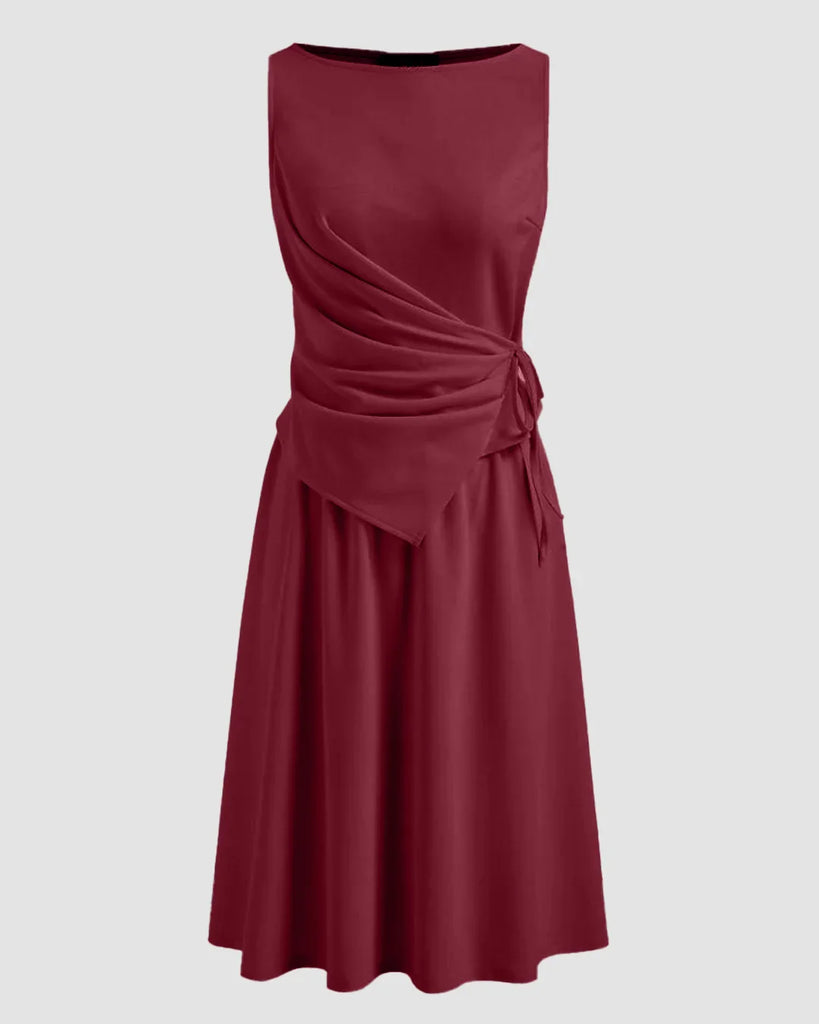 A burgundy A-line midi dress featuring a side tie knot at the waist, designed for a flattering silhouette.