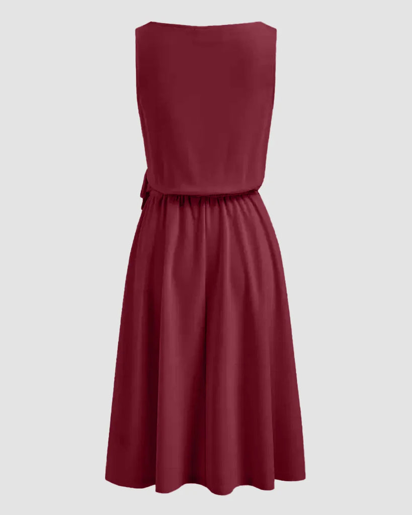 Back view of a burgundy A-line midi dress featuring a side tie knot at the waist, designed for a flattering silhouette.