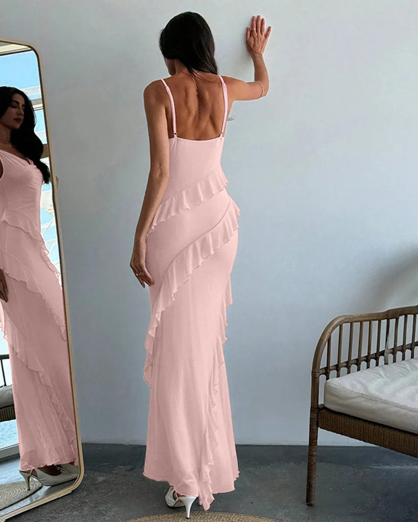 A light pink maxi dress featuring delicate ruffle details and spaghetti straps for a soft, feminine touch.