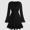 Front view of black full sleeve mini dress with ruched fit, ruffle hem and flared cuffs, elegant black full sleeve dress.