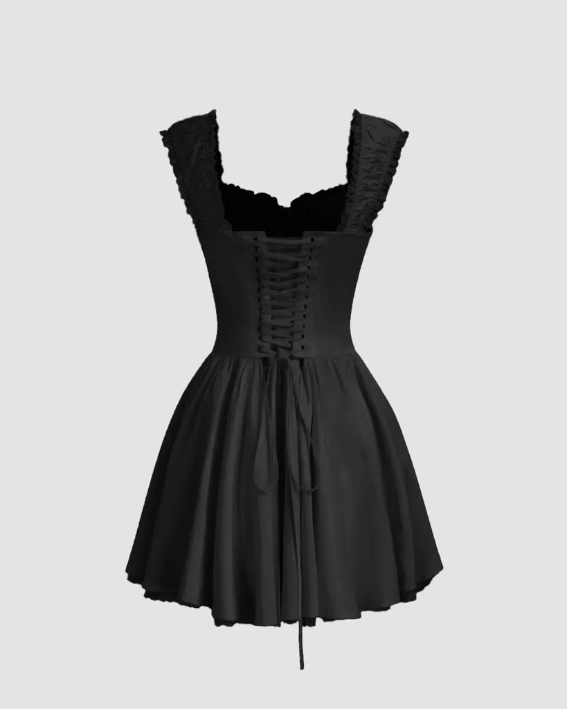 Back view of a Black fit & flare mini dress with ruffle straps, gathered bust, and flared skirt, perfect for casual outings and coffee dates.
