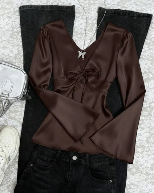Front view of Coffee brown satin deep V-neck top with a front tie detail and long flare sleeves, offering a sleek, fitted and elegant silhouette