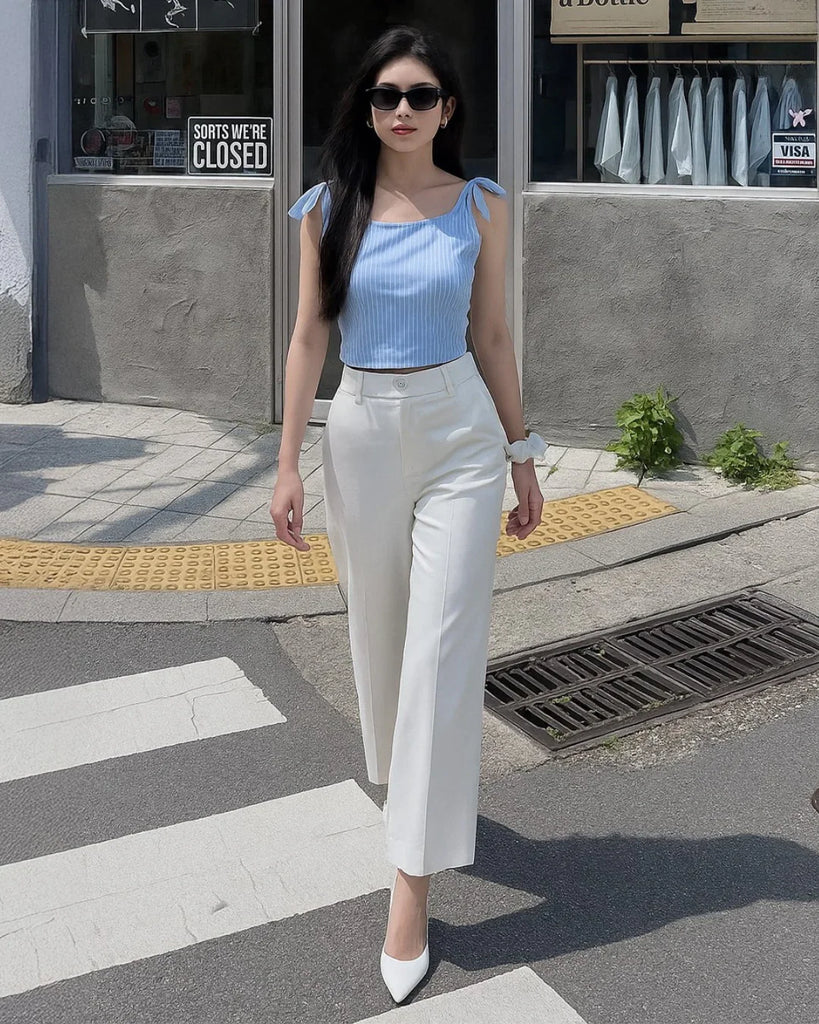 Sky blue ribbed tie-shoulder top paired with white wide-legged trousers in a stylish co-ord set.