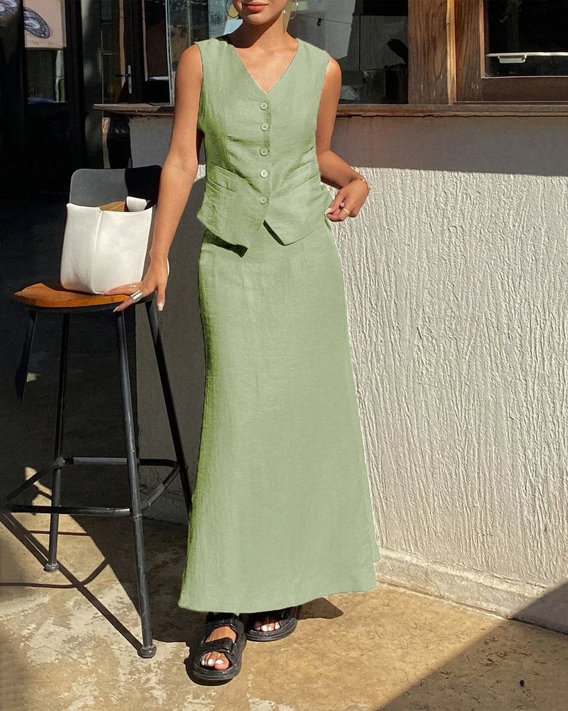 A woman wearing a sleeveless green dress and sandals, showcasing a light pista co-ord set with a maxi skirt.
