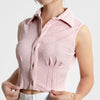 Baby pink sleeveless collared crop shirt with front buttons, designed in a textured crinkle fabric for a stylish touch