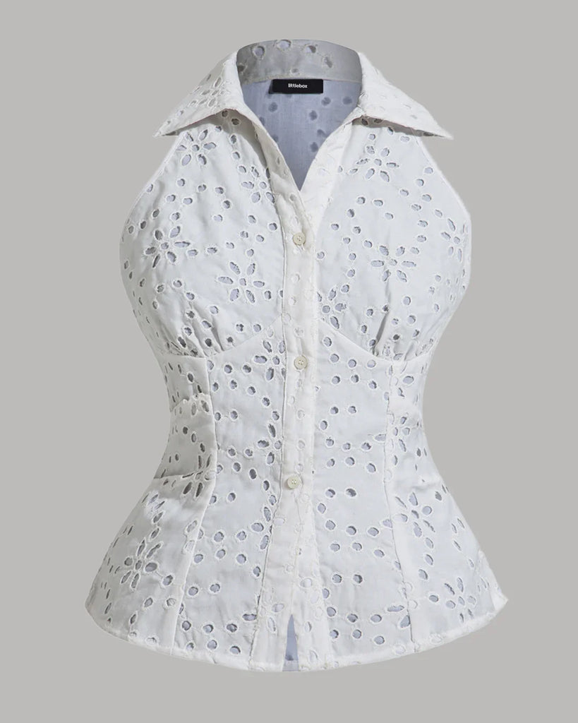 A sleeveless white blouse featuring a floral pattern, designed as a collared button-down top with eyelet details.
