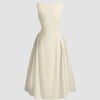 Sleeveless beige flared midi dress with a soft and flowy shape, ideal for daytime outings or casual events