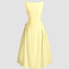 A sleeveless flared midi dress in vanilla, showcasing a vibrant color and a stylish, flowing design