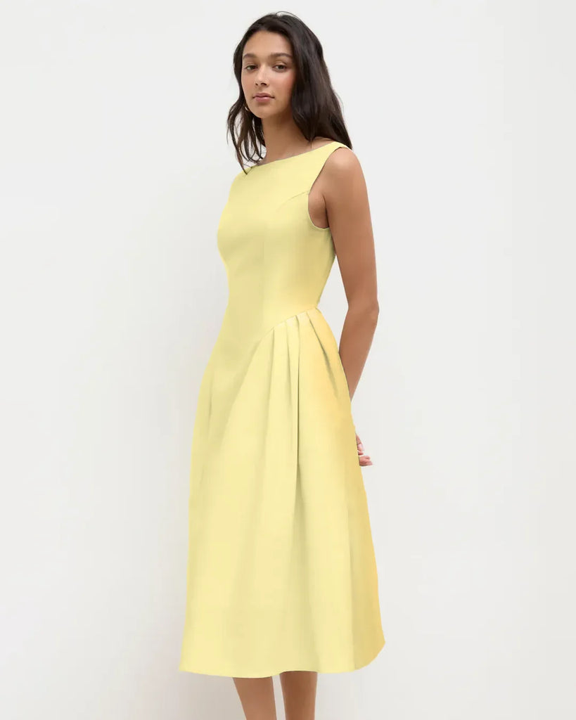 A sleeveless flared midi dress in vanilla, showcasing a vibrant color and a stylish, flowing design