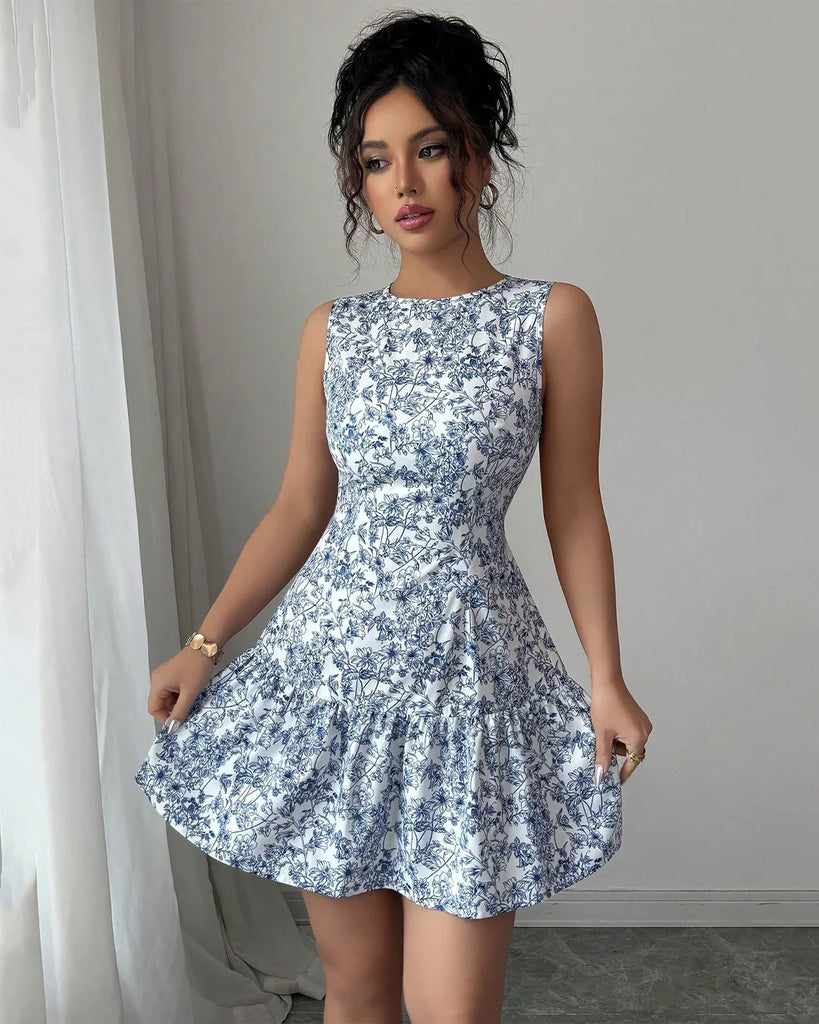 A woman in a sleeveless blue and white floral fit and flare mini dress