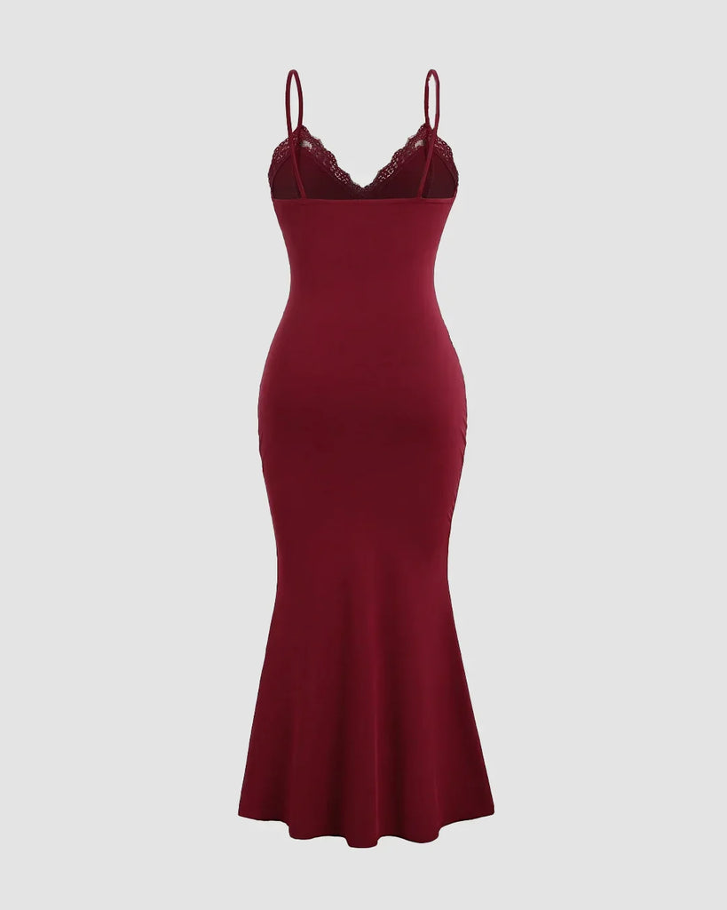 Back view of a Deep maroon bodycon dress with lace cups, adjustable straps, ruched bodice, and a flowing fishtail hem for a dramatic look