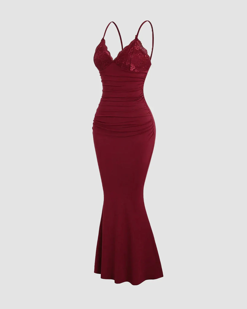 Deep maroon bodycon dress with lace cups, adjustable straps, ruched bodice, and a flowing fishtail hem for a dramatic look