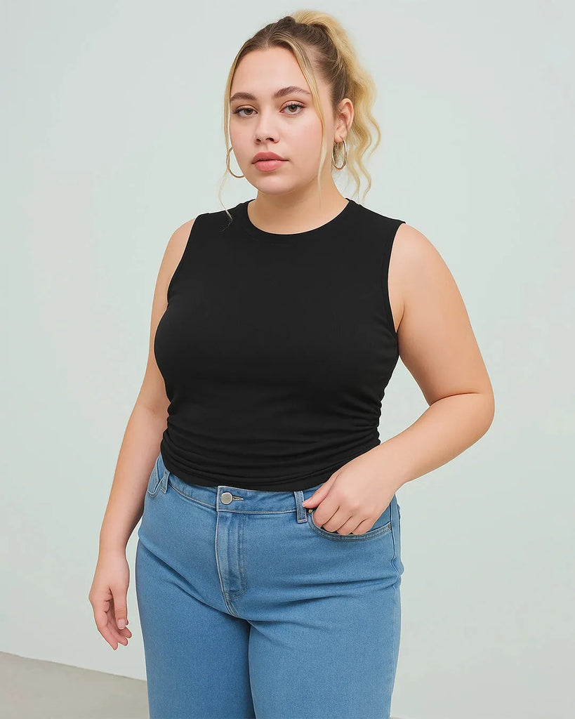 A women wearing black sleeveless crop top with ruched detailing, perfect for curve and plus sizes