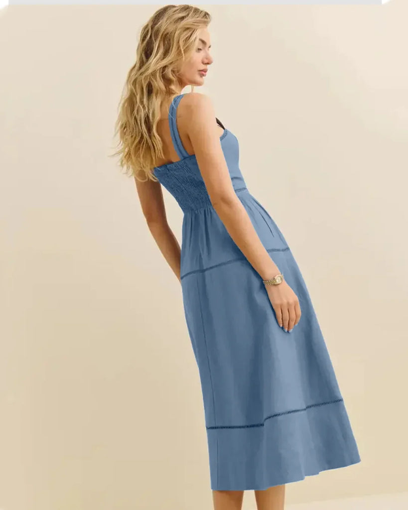 Model wearing a smocked back strap midi dress in French blue, showcasing a stylish and elegant design.