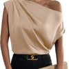 A woman in a peach satin top with batwing sleeves and black pants, showcasing a stylish asymmetrical neckline.