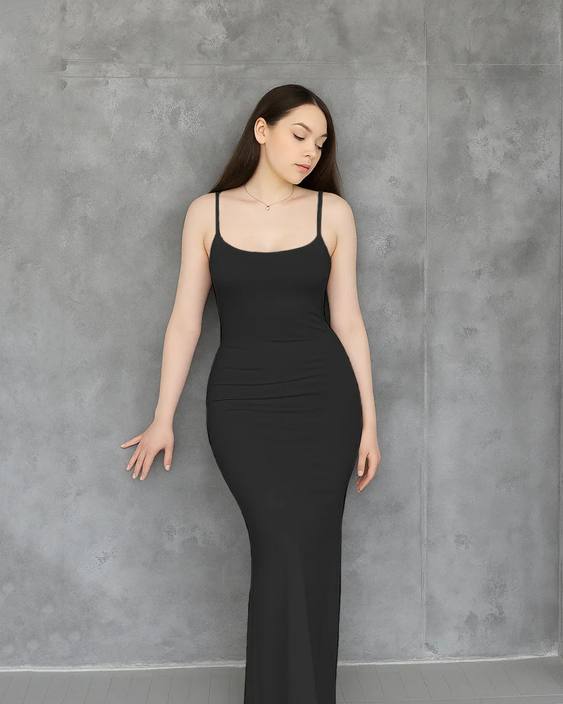 A sleek black maxi dress featuring thin straps and a contoured silhouette, offering a refined and effortlessly elegant look.