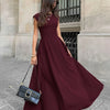 Front view of Solid burgundy crew neck fit and flare maxi dress with fitted bodice and elegant flowing skirt silhouette