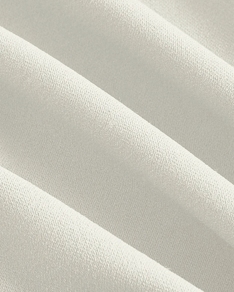 Close up of Milky white crop tank top with cross tie straps and lace-up sides, featuring a button-down detail for a stylish look