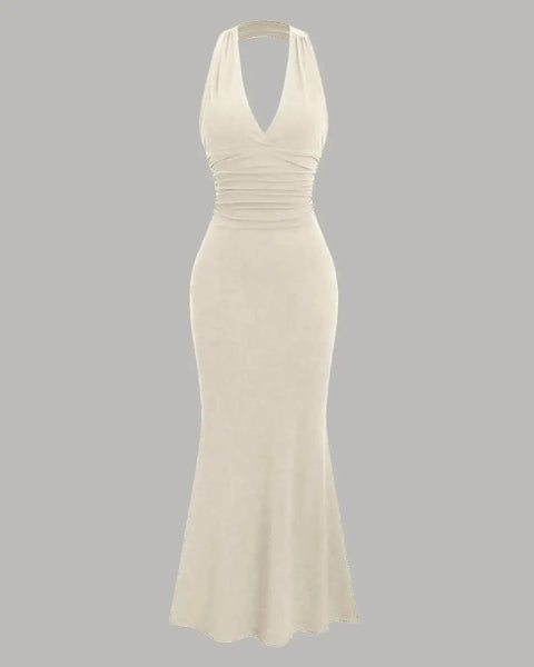 A solid beige mermaid bodycon dress featuring a halter neckline and backless design.
