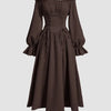 A chocolate brown off-shoulder dress featuring ruffled sleeves and a cross tie waist, elegantly flared at the bottom