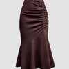 Brown skirt featuring a ruched hem, elegantly designed for a stylish and comfortable fit