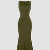 Green sleeveless dress featuring a square neckline and a pleated waist for a structured yet elegant silhouette.