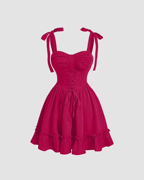 Solid pink vintage cross strap cami dress featuring ruffled shoulders, perfect for a stylish summer look