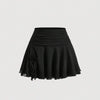 Front view of Short black skirt with ruched waistband, flared hem, and lightweight fabric for a playful casual look.
