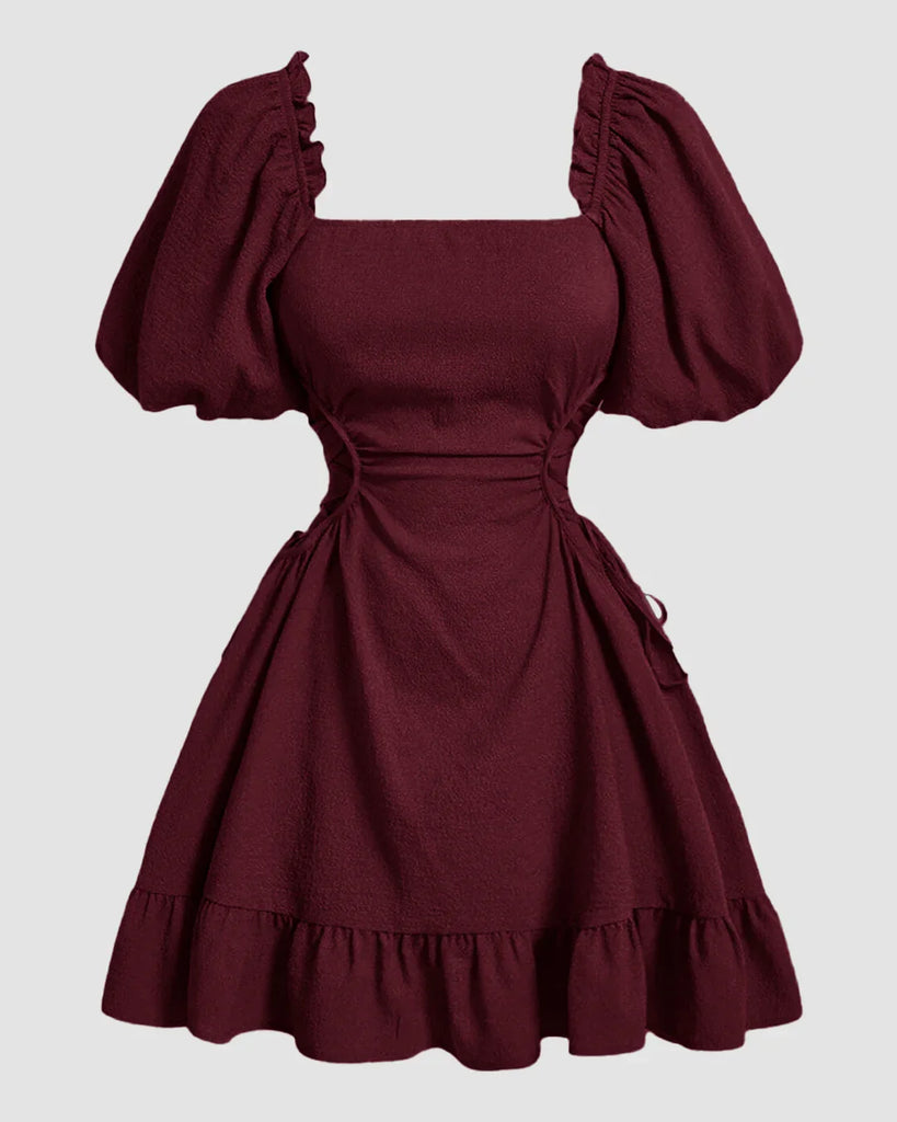  A maroon dress featuring ruffled sleeves and a lace-up side detail, showcasing a stylish and elegant design.