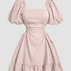 A powder pink dress featuring puff sleeves and ruffles, designed with a solid lace-up side detail.
