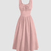 A solid powder pink dress featuring ruffles at the neckline and a ruched bust design.