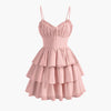 Powder pink cami dress featuring a ruched bust and ruffle hem for a soft, feminine touch.