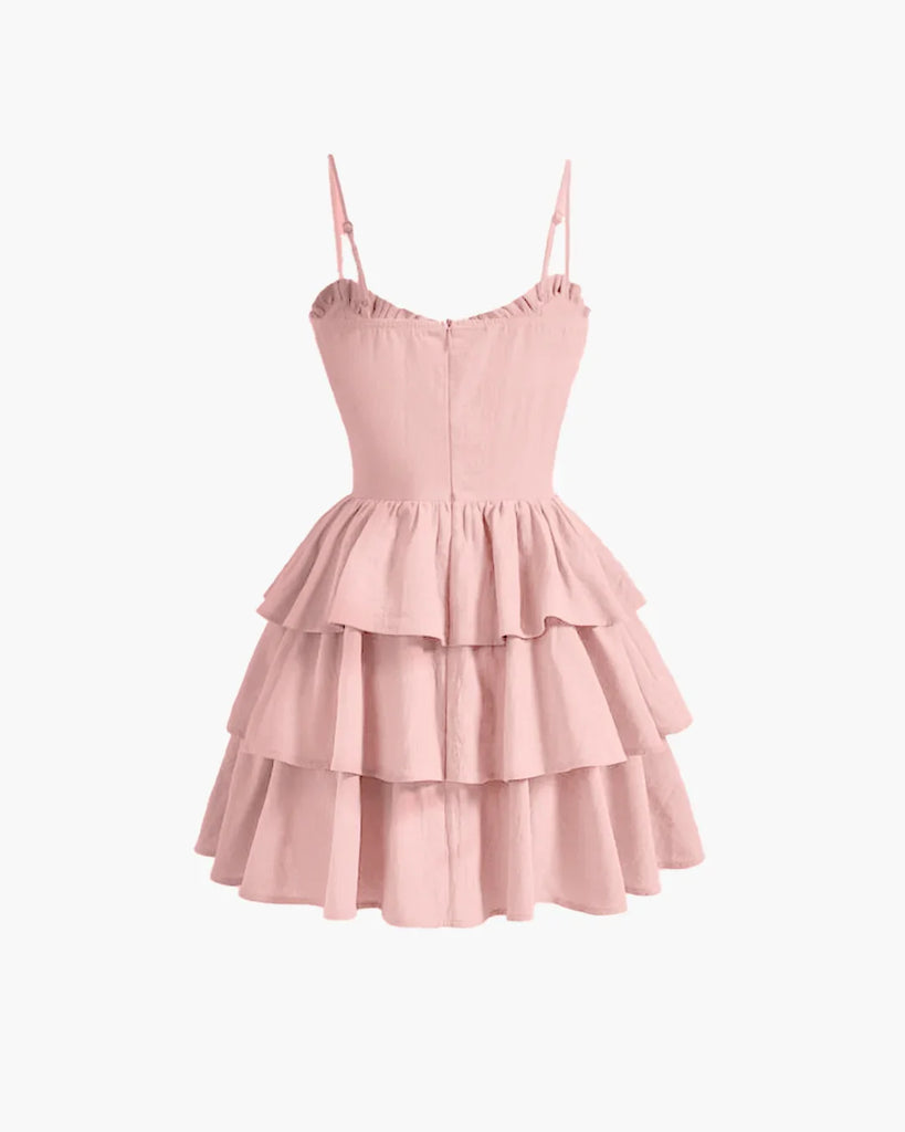 Back view of a Powder pink cami dress featuring a ruched bust and ruffle hem for a soft, feminine touch.