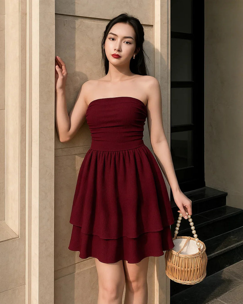 maroon tube dress with a ruched bust and ruffle accents, made from a rich red fabric