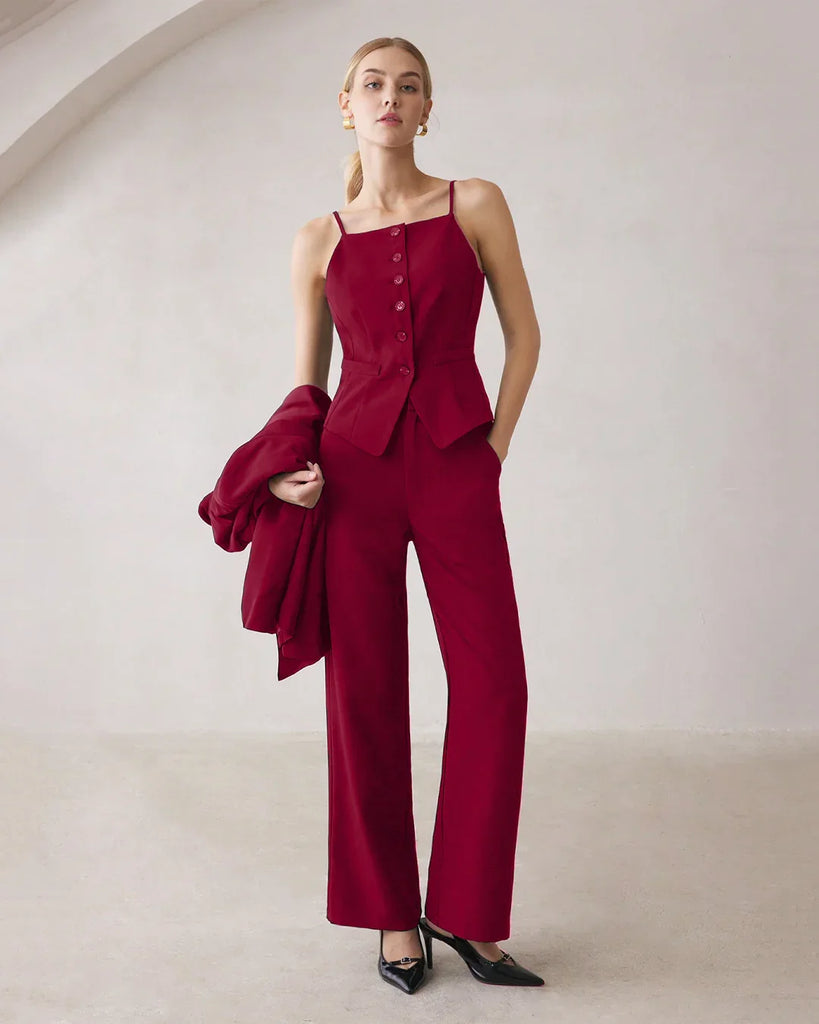 A model wearing a burgundy matching set, including a spaghetti strap button top and straight-leg trousers.