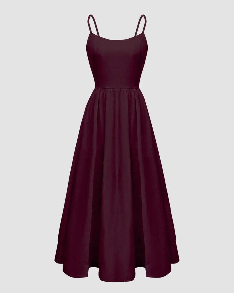 Burgundy spaghetti strap fit and flare sleeveless midi dress displayed on a mannequin against a neutral background.
