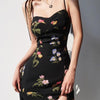 woman wearing black floral spaghetti strap dress with a side slit
