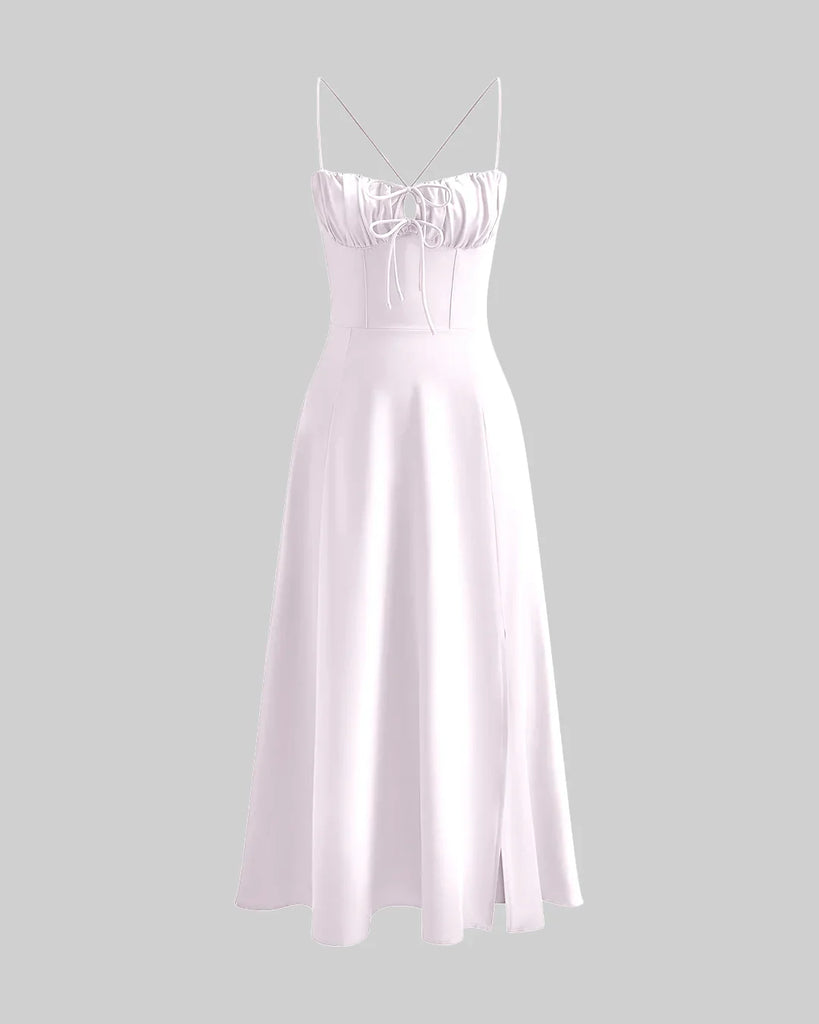 Baby pink spaghetti strap midi dress featuring a ruched bust and tie-front detail for a delicate, feminine touch.