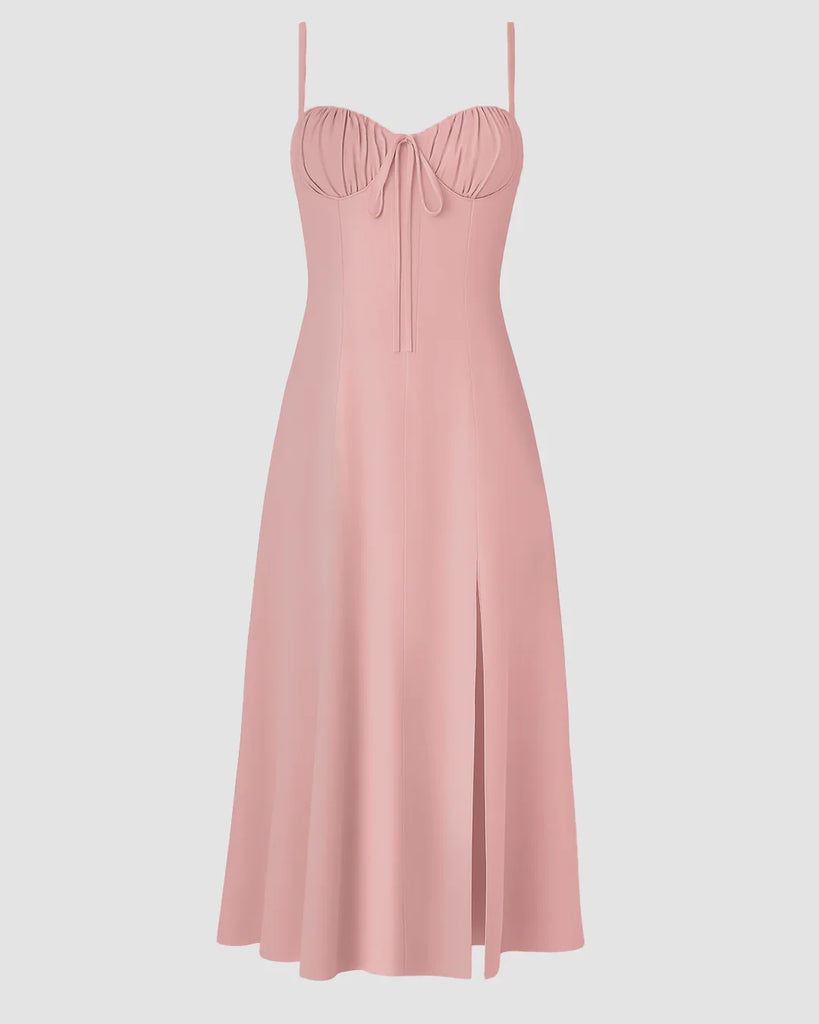 A pink spaghetti strap midi dress featuring a sweetheart neckline and a stylish bow detail.