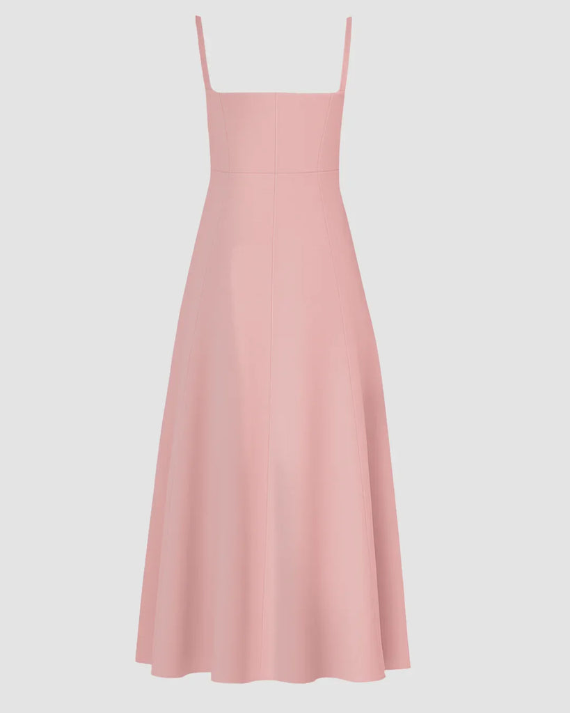 Back view of a pink spaghetti strap midi dress featuring a sweetheart neckline and a stylish bow detail.