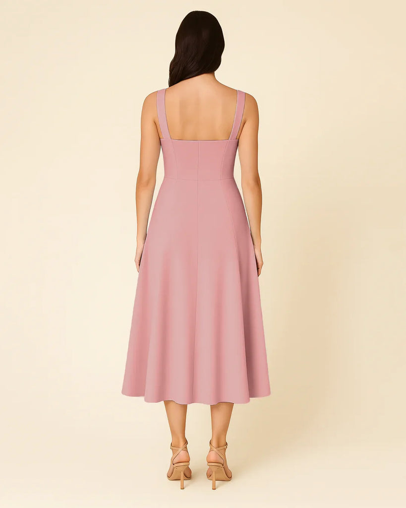 A pink spaghetti strap midi dress featuring a sweetheart neckline and a stylish bow detail.
