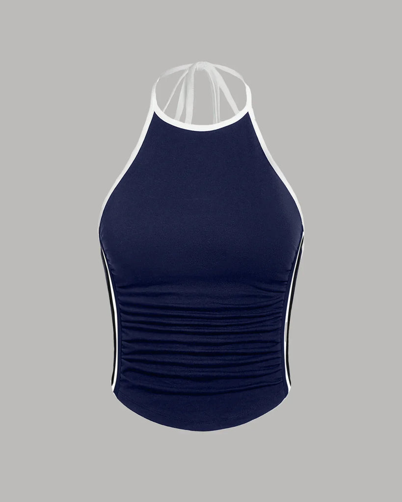 A navy blue and white sporty halter neck racerback top with ruched sides, perfect for an athletic look